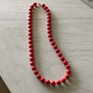 Red beads with gold separators.